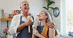 Karaoke, cooking and happy with old couple in kitchen for bonding, love and meal prep. Connection, support and food with senior man and woman and spoon in home for retirement, singing and music