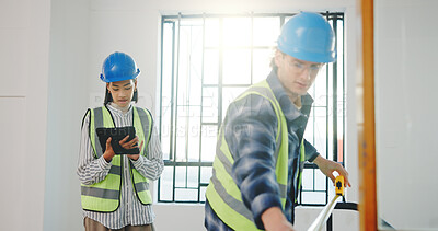 Buy stock photo Maintenance, team and tablet in building with measurement, design update and renovation planning. Man, woman and tech at worksite for project management, property assessment and compliance review