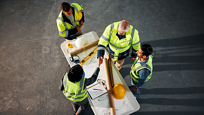 Buy stock photo Above, engineer and shaking hands on site with blueprint, design approval and property development. Engineering deal, people and handshake in building with manager, floor plan validation and success.