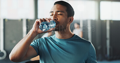Buy stock photo Fitness, man and drinking with water in gym for hydration, sustainability or workout break. Active, male person or bottle with mineral liquid or aqua beverage for recovery or wellness in health club