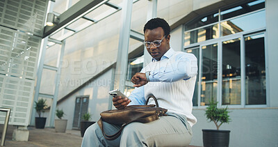 Buy stock photo Phone, businessman and check watch for delay, transportation wait or time management in city. Black person, mobile and impatient with wristwatch for late travel service, hailing app or trip stress