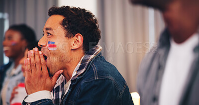 Buy stock photo Man, shocked and watching tv in home for sports, anticipation or face paint with national flag. Fan, excited or streaming game with friends for tournament win, live event or international competition