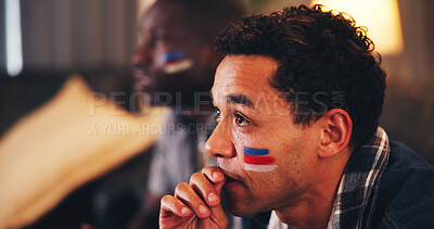 Buy stock photo Man, sports and watching tv in home with waiting, anticipation and face paint with national flag. Fan, anxiety and streaming game with friends for tournament, live event and international competition