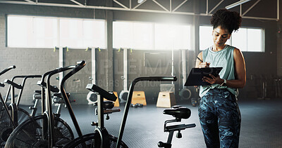 Buy stock photo Woman, fitness or checklist with bicycle in gym for inventory inspection or workout equipment. Active, female person or checking clipboard with stationary bikes for functionality or quality assurance
