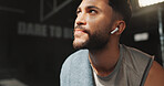Thinking, earphones and fitness with man in gym for workout rest, reflection and sports athlete. Exercise, music streaming and training with person in club for wellness, body builder and vision