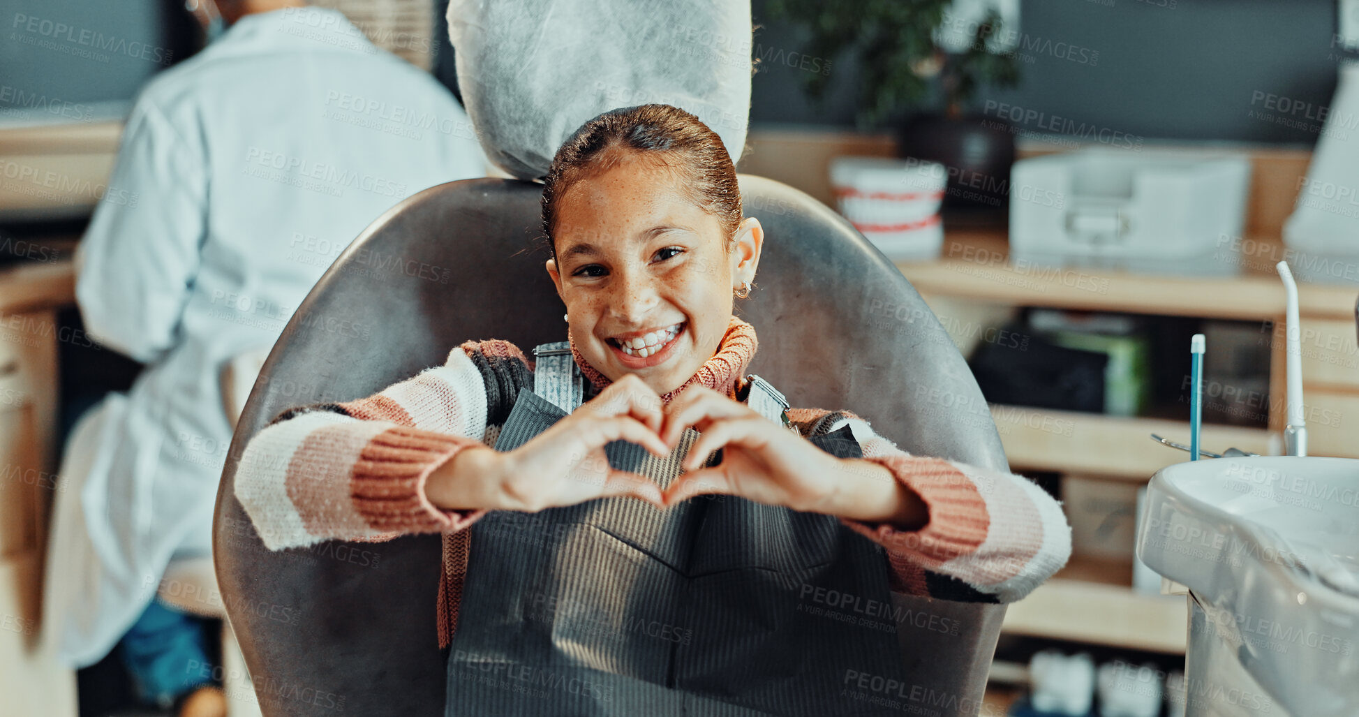 Buy stock photo Portrait, girl and heart hands with dentist in clinic for oral hygiene, treatment or satisfaction. Child, kid or patient with smile, like emoji or love for dental appointment, gum care or healthcare
