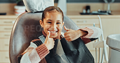 Buy stock photo Portrait, girl and thumbs up with smile in clinic for oral hygiene, treatment or satisfaction. Happy, child or kid with like emoji, yes sign or OK for dental appointment, gum care or healthcare