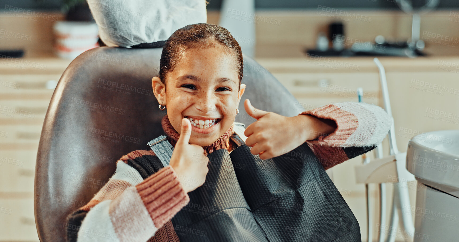 Buy stock photo Portrait, girl and thumbs up with smile in clinic for oral hygiene, treatment or satisfaction. Happy, child or kid with like emoji, yes sign or OK for dental appointment, gum care or healthcare