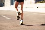 Fitness, active and legs in city with running, cardio and stamina exercise in physical activity. Training, space and female person outdoor with jog, sports hobby and athletic workout in town.
