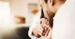Couple, kiss and holding hands with partner in house, bonding and relationship commitment in lounge. Marriage, loyalty and support for spouse, people and solidarity for love and partnership in home