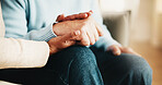 Old couple, bonding and holding hands with partner in house, retirement and relationship commitment. Marriage, solidarity and senior people on break, physical touch and support with love in home