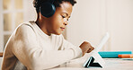 Child, headphones and elearning in home with tablet, cognitive development or learn digital literacy. Boy, scroll and search video in house with audio tech, online education and knowledge growth.