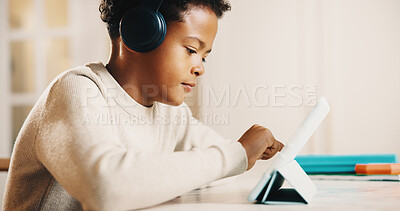 Buy stock photo Child, headphones and elearning in home with tablet, cognitive development or learn digital literacy. Boy, scroll and search video in house with audio tech, online education and knowledge growth.