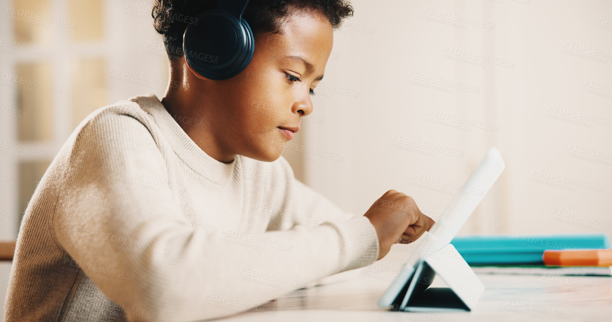 Buy stock photo Child, headphones and elearning in home with tablet, cognitive development or learn digital literacy. Boy, scroll and search video in house with audio tech, online education and knowledge growth.