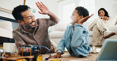 Buy stock photo Son, dad and high five with toy car for engineering or remote control vehicle in home together. Family, child and learning with father for success with robotic build, junior mechanic or development