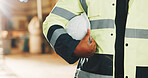 Hands, person and helmet in warehouse for inspection, safety and compliance for shipping. Inspector, ppe and protocol in factory with hardhat, protection and workplace uniform for distribution policy