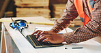 Typing, man and hands of woodworker with laptop in workshop for research on industrial project. Technology, email and carpenter with computer for feedback on furniture manufacturing in factory.
