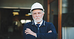 Architect, portrait and man with arms crossed on construction site, serious or property development. Confident, civil engineer and mature person with helmet, project management and renovation in USA