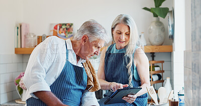 Buy stock photo Mature, couple and cooking in kitchen with tablet, reading online recipe and love bonding together. Married people, research and browsing in home with tech, meal prep instruction and help partner.