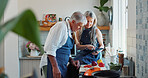 Cooking, tablet or senior couple in kitchen with recipe, food blog or connection with meal prep. Reading, help or elderly people in home with tech, online instructions or bonding in culinary hobby.