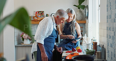 Buy stock photo Cooking, tablet or senior couple in kitchen with recipe, food blog or connection with meal prep. Reading, help or elderly people in home with tech, online instructions or bonding in culinary hobby.