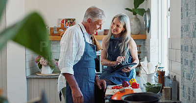 Buy stock photo Cooking, tablet and elderly couple in kitchen with recipe, food blog and connection with meal prep. Smile, help and senior people in home with tech, online instructions and bonding in culinary hobby.
