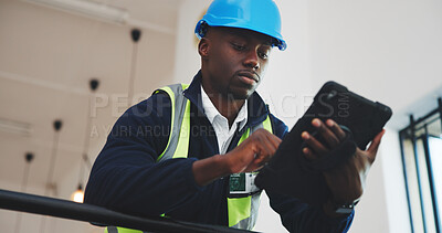 Buy stock photo Engineer, man and scroll in office with tablet, design building or research for property development. Low angle, black person and typing in workplace with tech, internet and planning for engineering.