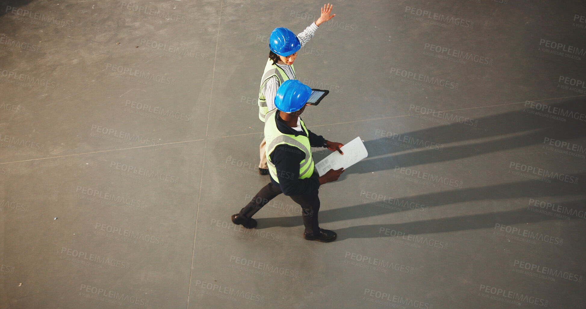 Buy stock photo Architect, team and walking with tablet in warehouse for construction planning or instructions. Top view, people or civil engineer with documents or technology for building or architecture on space