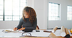 Architect, writing and woman in office with notebook, design plan and draft of renovation project. Development, review and engineer with notes, progress checklist and strategy brief for remodeling.