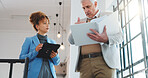 CEO, businessman and documents with assistant in office building for business schedule or tasks. Mature, man or executive with binder or assistance for company agenda, planning or report in workplace