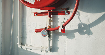Buy stock photo Red, building and fire hose with emergency equipment for security, health and safety. Empty, pipes or pressure with concrete wall for natural disaster, hazard protection or first aid tool in facility