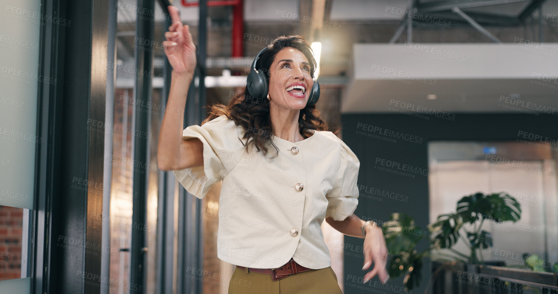Buy stock photo Streaming, dance and woman in office with headphones, song rhythm and listening to music playlist. Happy, tech and mature employee with fun time, upbeat groove and radio subscription on audio app.