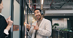Excited, pointing and smile of business man in office for financial collaboration or development. Greeting, headphones and music with happy employee in corporate workplace corridor for arrival at job