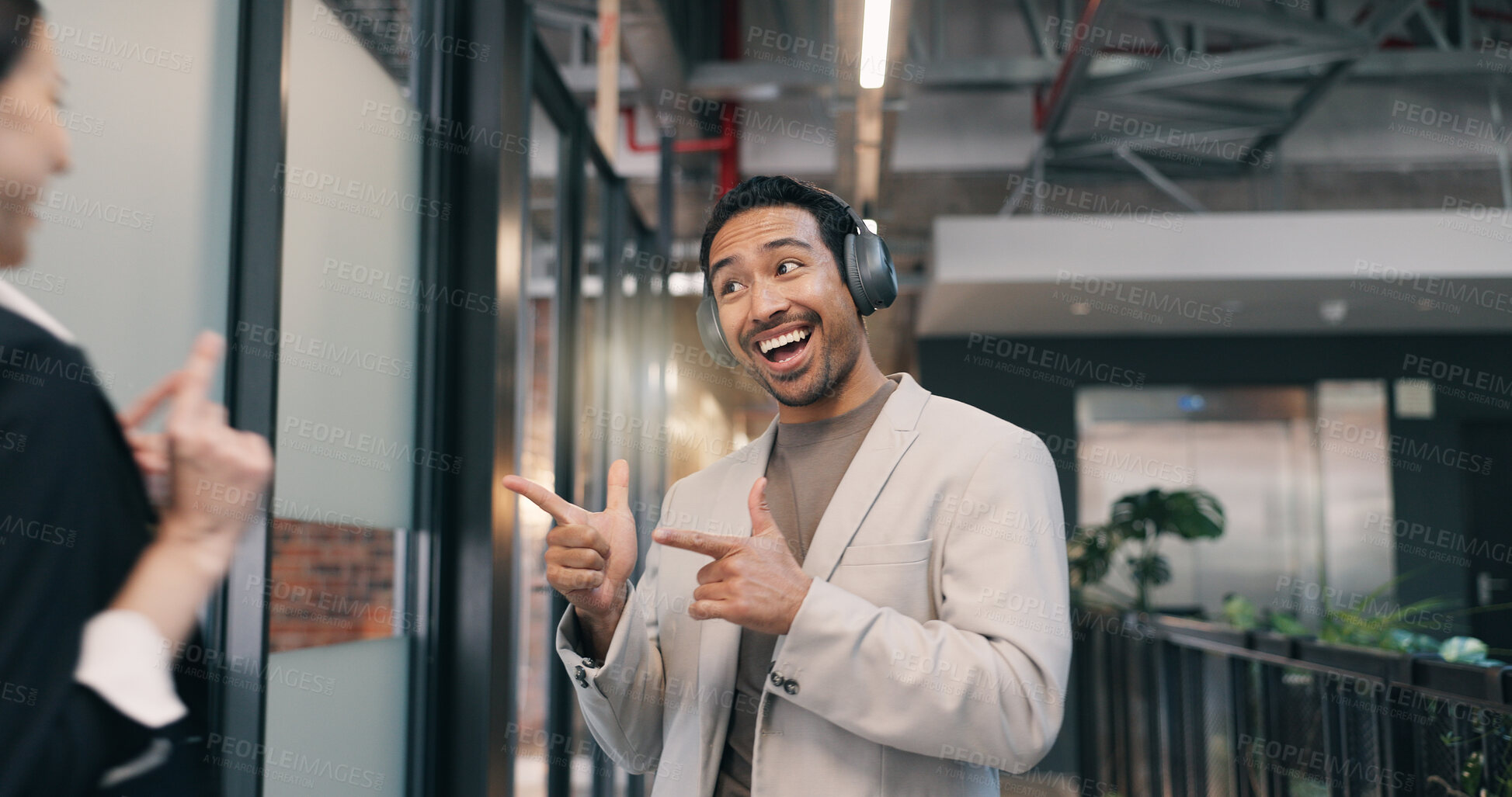 Buy stock photo Excited, pointing and smile of business man in office for financial collaboration or development. Greeting, headphones and music with happy employee in corporate workplace corridor for arrival at job