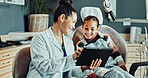 Dentist, woman and tablet with girl, advice and appointment for checkup. Child healthcare, explanation and consulting with digital tech for dental care, oral hygiene and cleaning service in clinic