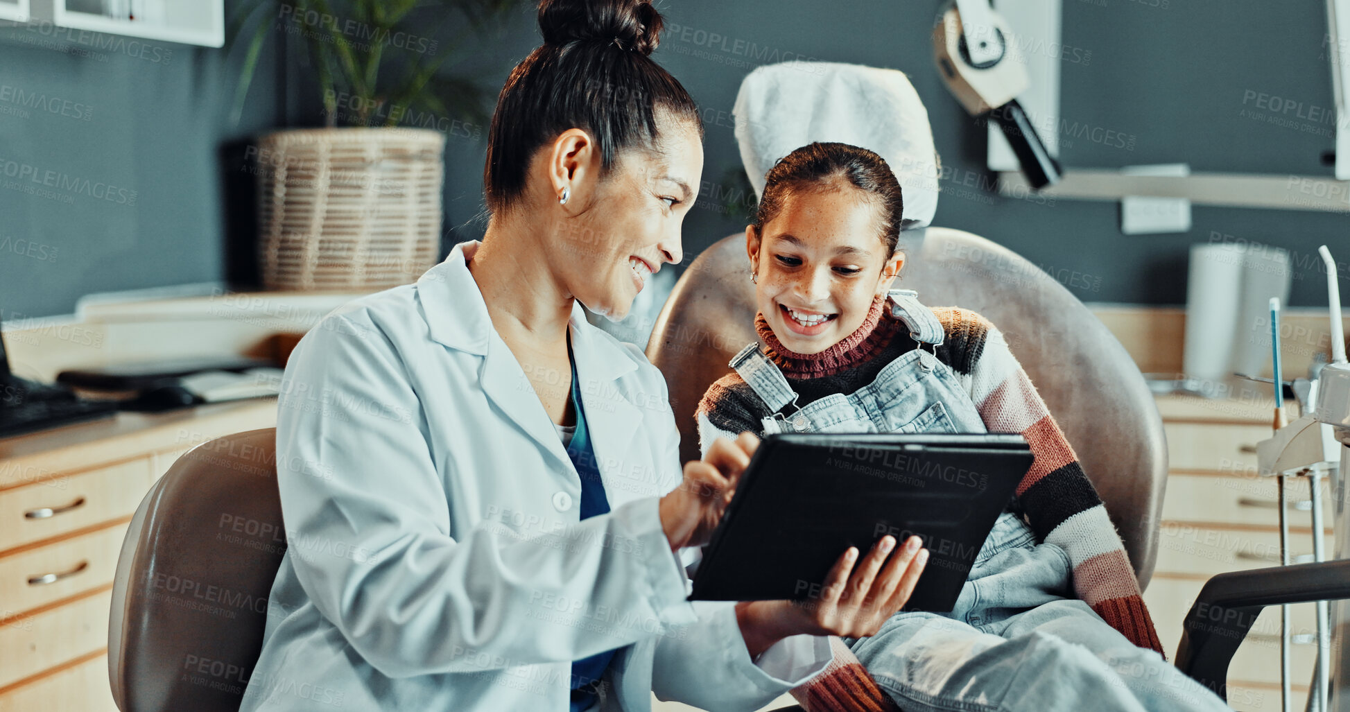 Buy stock photo Dentist, woman and tablet with child, advice and appointment for checkup or cleaning service. Orthodontist, happy girl or consulting with digital tech for dental care, oral hygiene or smile in clinic