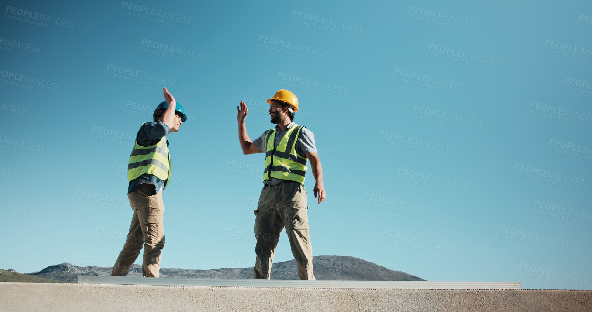 Buy stock photo High five, outdoor and construction team on site for building, repairs or renovation in collaboration. Men, space and civil engineer with foreman for celebration on property development on rooftop.