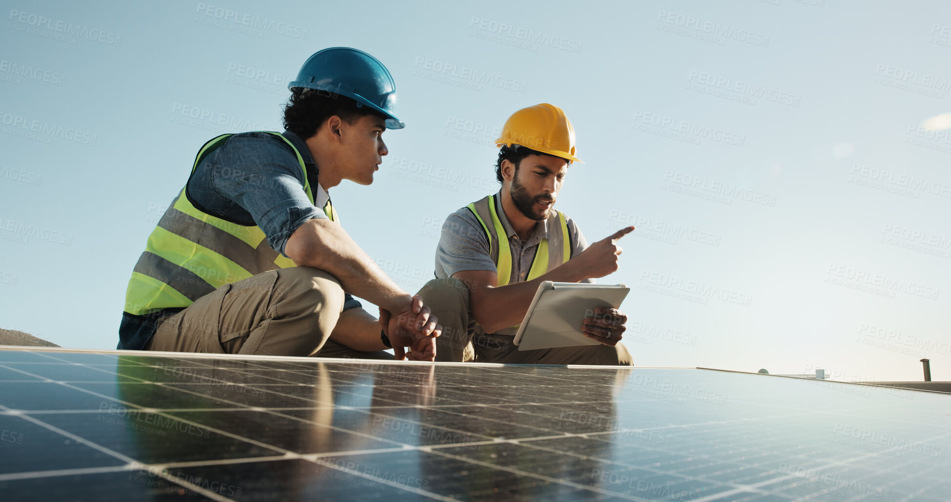 Buy stock photo Technician, team and solar panel on rooftop with tablet, planning upgrade or engineering design. Men, talking and tech with photovoltaic grid for project management with energy source at eco building
