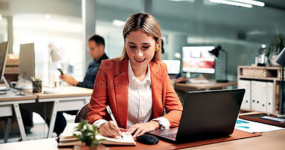 Buy stock photo Woman, laptop and writing in office with diary, record data and revenue analysis for company report. Coworking, person and analyst with computer, planner notes and graphs for business sales stats.