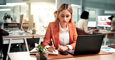 Buy stock photo Woman laptop and writing in office with notebook, record data and sales analysis for company report. Coworking, person and analyst with computer, planner notes and graphs for business revenue stats.