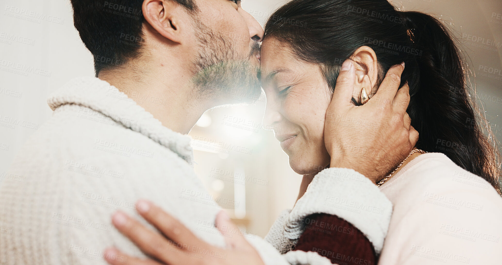 Buy stock photo Forehead, kiss and happy couple in home, love and bonding with partner on break or marriage loyalty. House, flare and connection with spouse, relationship commitment and people with smile on weekend