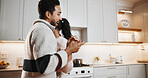 Couple, dancing and holding hands at house with love, partner support and romantic moment. People, singing and moving in kitchen with rhythm, spouse affection and romance morning for weekend unwind