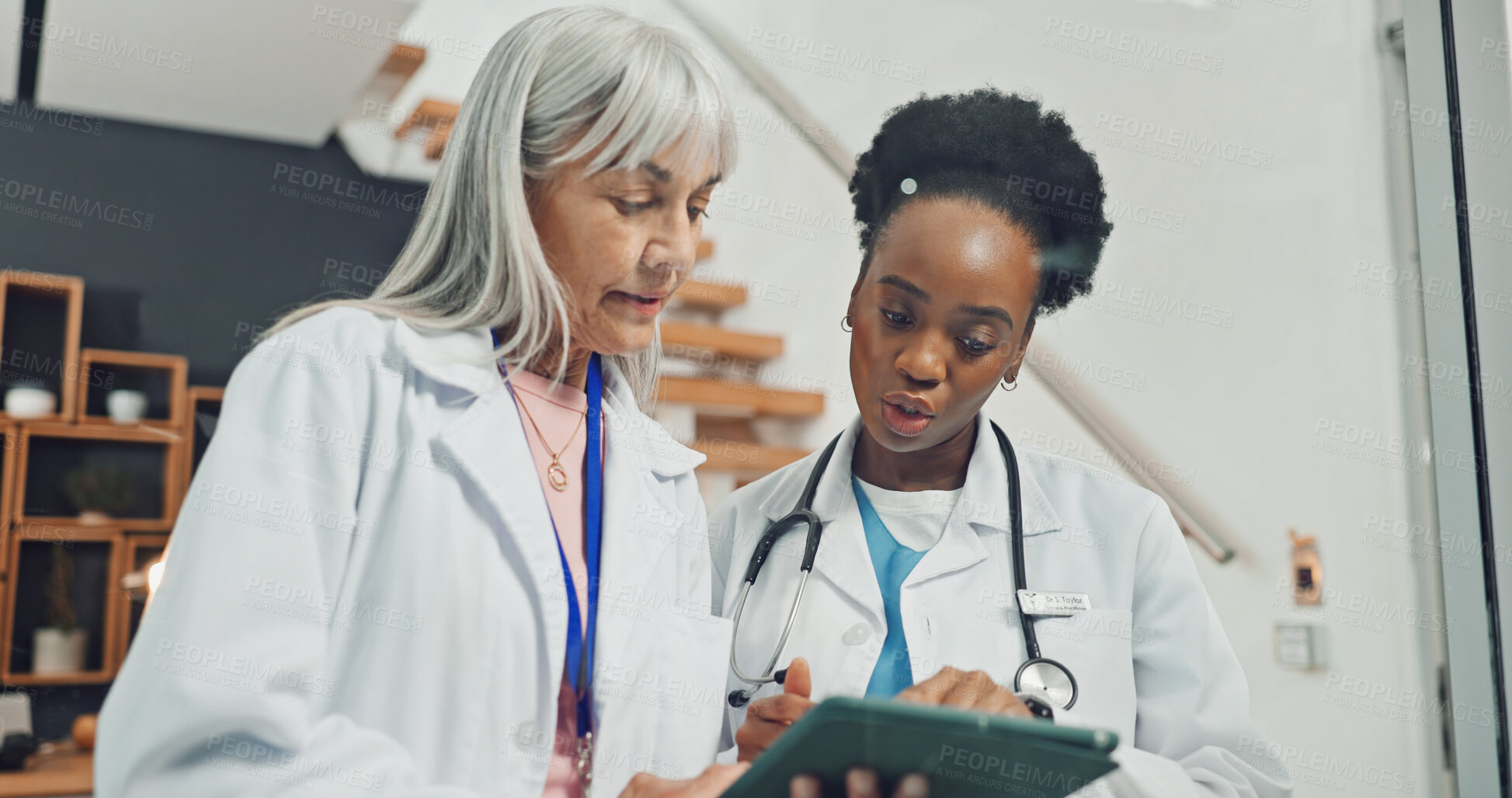 Buy stock photo Doctors, talking and women with tablet in office, teamwork or manager with medical advice on website. Healthcare, collaboration and people with tech, treatment plan and reading test results in clinic