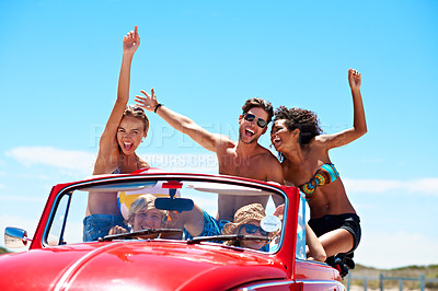 Buy stock photo Excited, friends and arms up in car with summer holiday, road trip and adventure for bonding outdoor. Portrait, happy people and drive in convertible vehicle with reunion, journey or travel vacation.