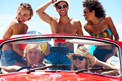 Buy stock photo Travel, friends and road trip in car for holiday, drive or excited for summer vacation together. Convertible, laugh or people on journey with smile, beach ball or bonding outdoor in vintage transport