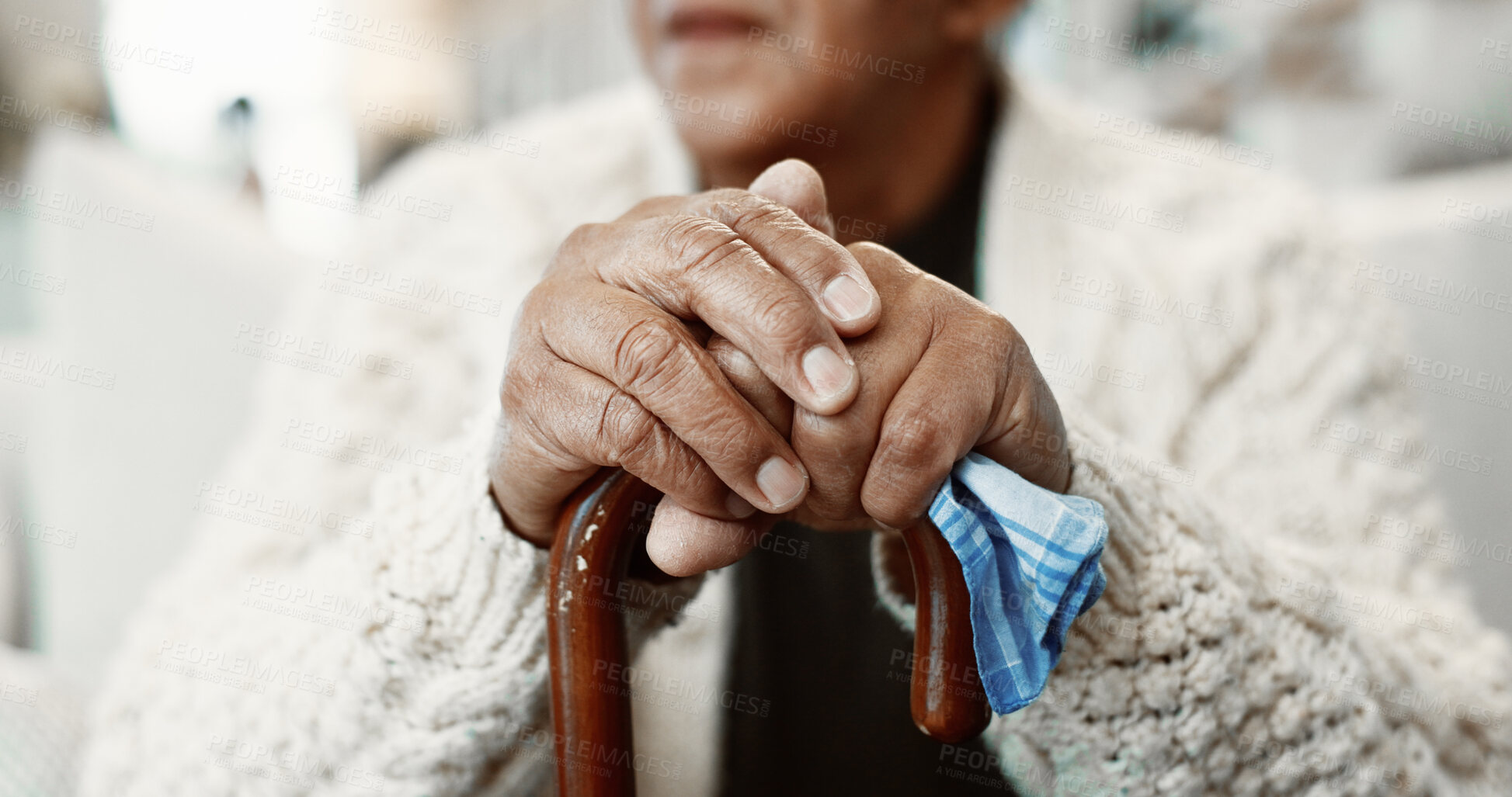 Buy stock photo Senior, man and hands with cane in retirement home for balance, support or nostalgia. Closeup, male person or thinking with walking stick for elderly care, aid or reminisce on sofa in old age house