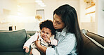 Mom, comfort and crying with baby on sofa for emotional support, regulation or stimulation in home. Mother, child or sad kid with hug for teething, childhood growth or gentle parenting in house