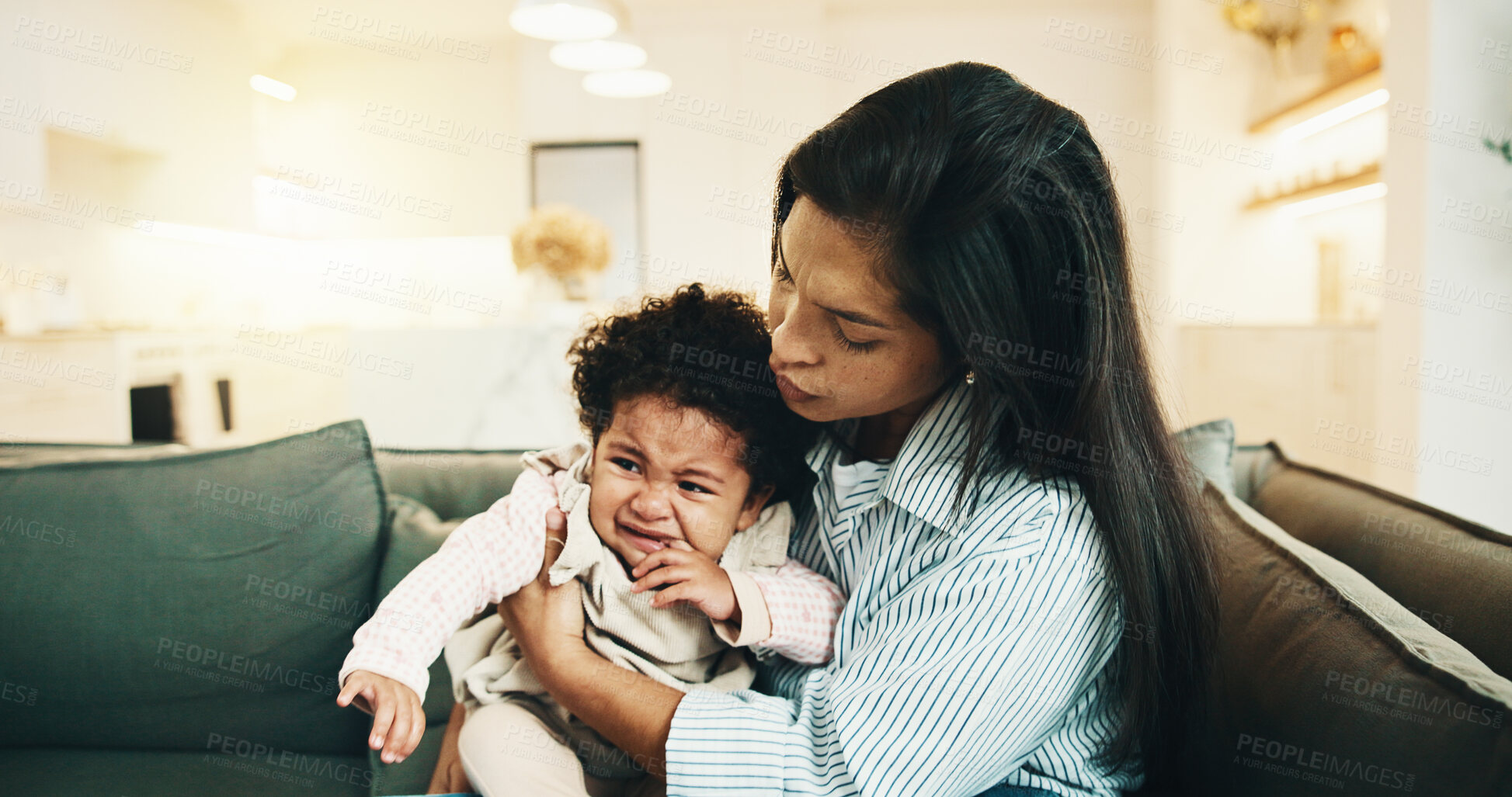 Buy stock photo Mom, comfort and crying with baby on sofa for emotional support, regulation or stimulation in home. Mother, child or sad kid with hug for teething, childhood growth or gentle parenting in house