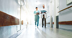 Background, blur and doctors walking in hospital corridor for discussion, planning or teamwork. Conversation, healthcare and medical professional people in hallway of clinic for feedback or review