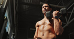 Thinking, gym and bodybuilder man with dumbbells or weights for training, exercise and self care. Iron, workout and person with health club membership for fitness, strong arm muscle and wellness